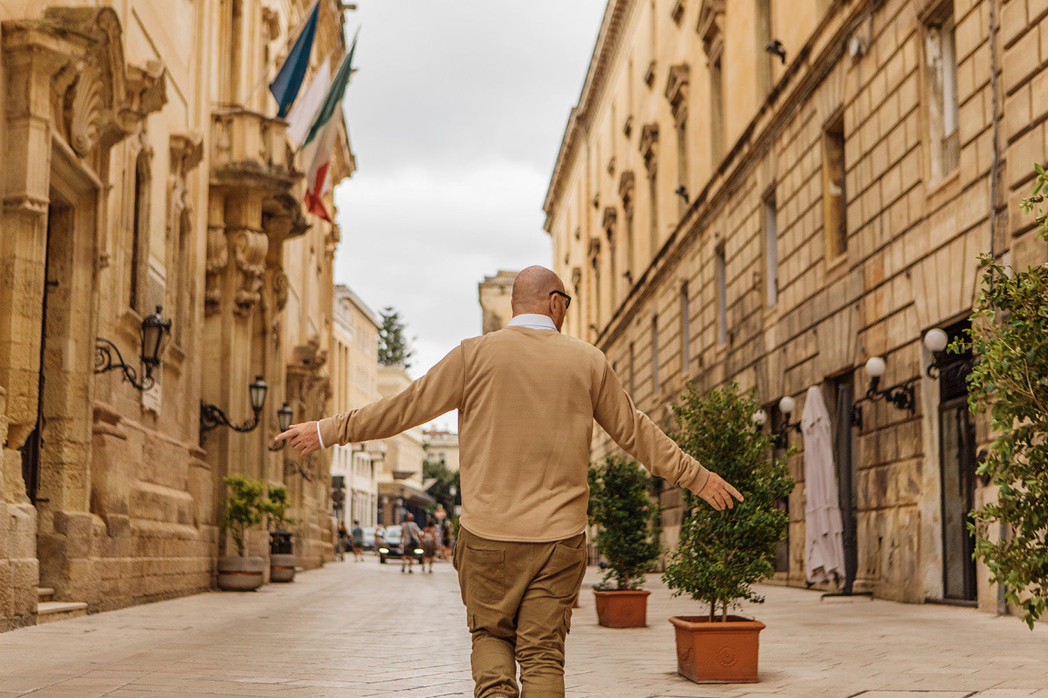 A man enjoying the architectural beauty of Lecce, Italy.